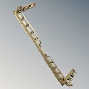 A Victorian brass fire curb