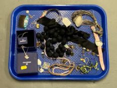 A Swarovski crystal swan pendant on chai