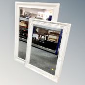 Two contemporary white framed mirrors.