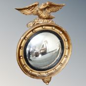 A vintage gilt chalk porthole mirror surmounted by an eagle.
