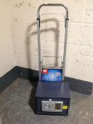 A digital safe together with an Einhell aluminium sack barrow.