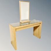 A contemporary glass topped vanity table fitted a drawer with light up mirror