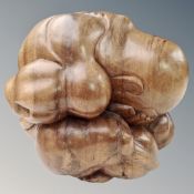 A large carved wooden Buddha figure with head in hands,