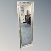 A contemporary hall mirror in a silvered frame.