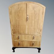 A 1930s walnut dome topped linen cabinet fitted with two drawers.