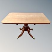 A 19th century mahogany pedestal breakfast table on brass capped feet.
