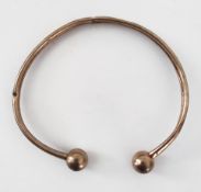 A 9ct gold bangle weighing 4 grams.