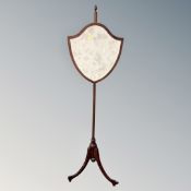 A mahogany and beech pole screen on tripod stand.