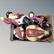 Two contemporary hot air balloon hanging ornaments together with a further Laurel and Hardy figure
