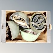 A box of four military tin helmets