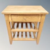 A light oak storage table fitted a drawer