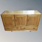 An Ercol elm low sideboard