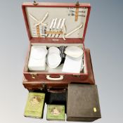 A vintage leather luggage case together with a mid 20th century Optina picnic set together with