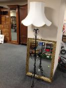 A gilt framed over mantel mirror together with wrought iron standard lamp with shade