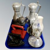 A 19th century cast iron cat door stop together with two cast flat irons,