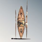 A decorative African shield and three spears