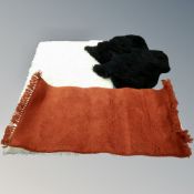 A contemporary cream shaggy pile rug 175 cm x 100 cm together with three further smaller rugs