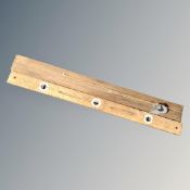 A vintage wooden spirit level together with a shaft sinker's plumb bob