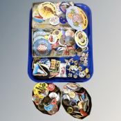 A tray of tins, vintage pin badges,