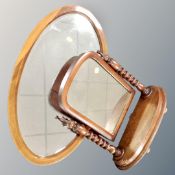 A Victorian mahogany toilet mirror with twist columns together with a further antique oval mirror