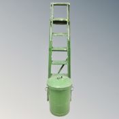 A pair of wooden step ladders together with a metal bin