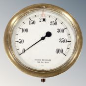 A circular brass cased pressure gauge, diameter 35 cm.