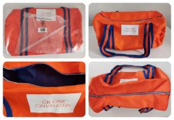 A Calvin Klein Ck One orange Duffle Bag.