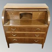 A continental cylinder bureau and a tile topped nest of tables