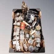 A box of assorted novelty metal money boxes, vintage table lighters,