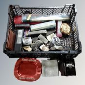 A basket of table and pocket lighters, ashtrays, whistles,