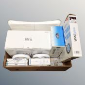 A boxed Nintendo Wii games system together with Wii fit board, games,