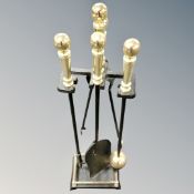 A four piece companion set on stand