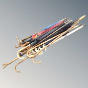 A large quantity of vintage and later walking sticks and umbrellas