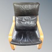A black leather and beech framed relaxer chair