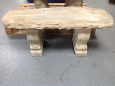 A concrete garden bench