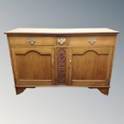 An Edwardian oak sideboard