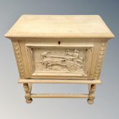 A 20th century carved oak storage box with iron handles