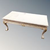 A carved low table with painted decoration