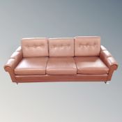 A light tan continental three seater button settee with a pair of matching armchairs