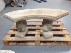 A shaped concrete bench on squirrel pedestals