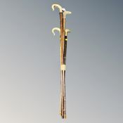 A bundle of four walking sticks and shepherd's crooks.