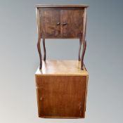 A stained beech wood double door cabinet and a teak cabinet