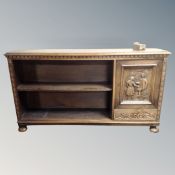 A continental oak bookcase fitted with a cupboard