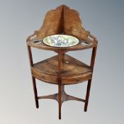 A George III mahogany corner wash stand with bowl