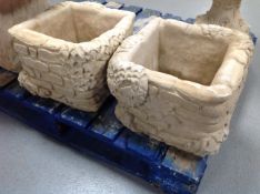 A pair of square concrete planters