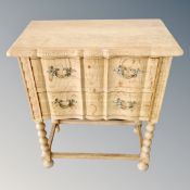 A continental light oak two drawer table