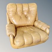 A 20th century light tan leather buttoned armchair