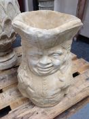 A concrete planter in the form of a toby jug