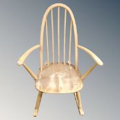 An Ercol white elm rocking chair