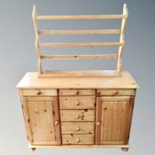 A pine side cabinet fitted with drawers and a pine plate rack